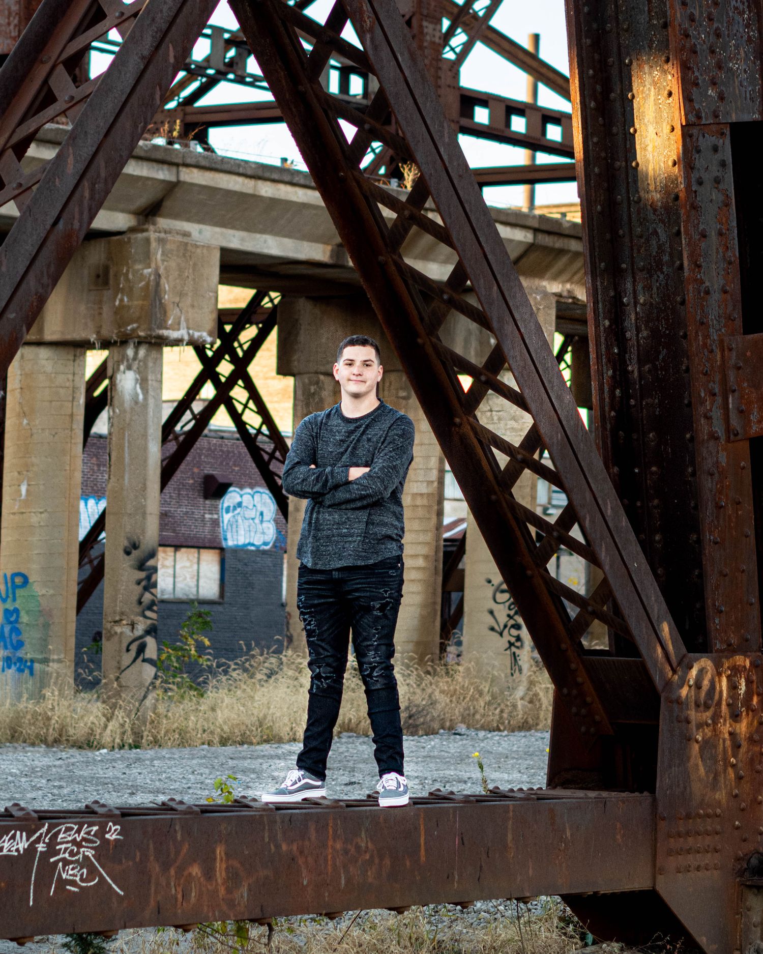 Urban photography session on rusty railroad bridge structure.