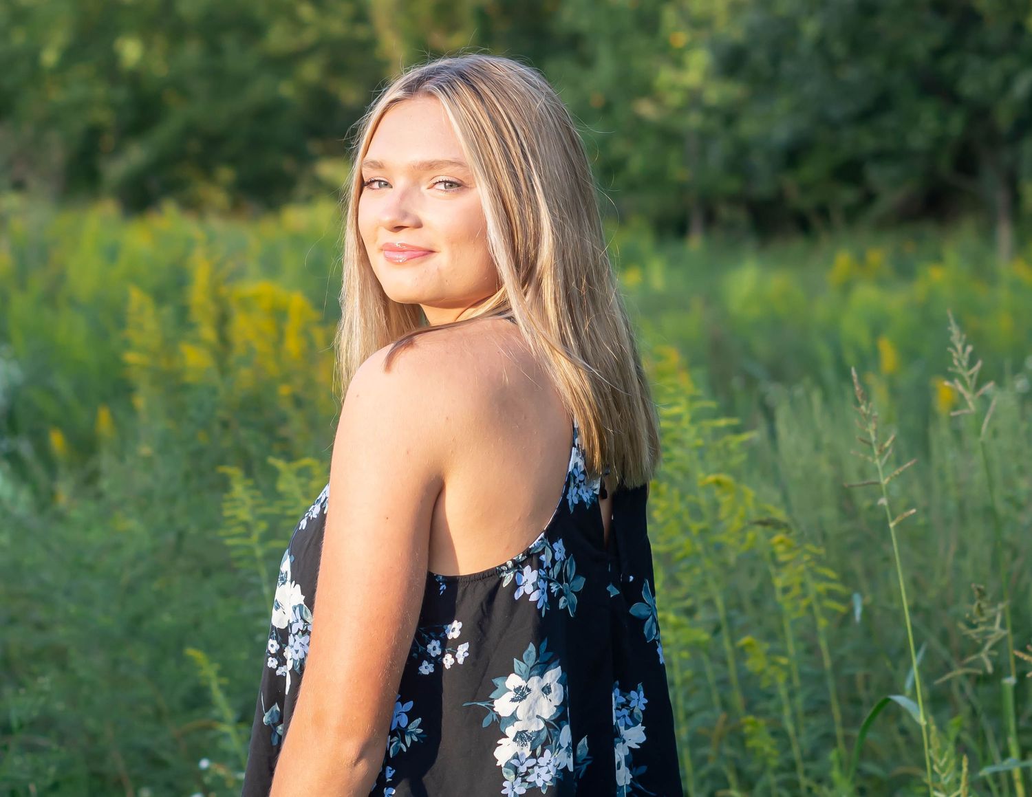 Summer portrait session in field with floral dress.