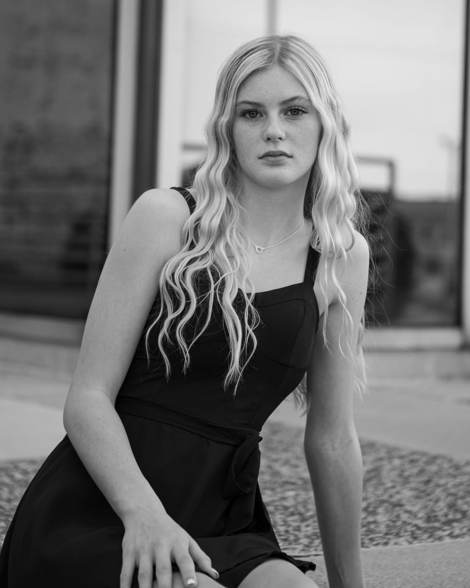 Black and white portrait series against brick wall backdrop.