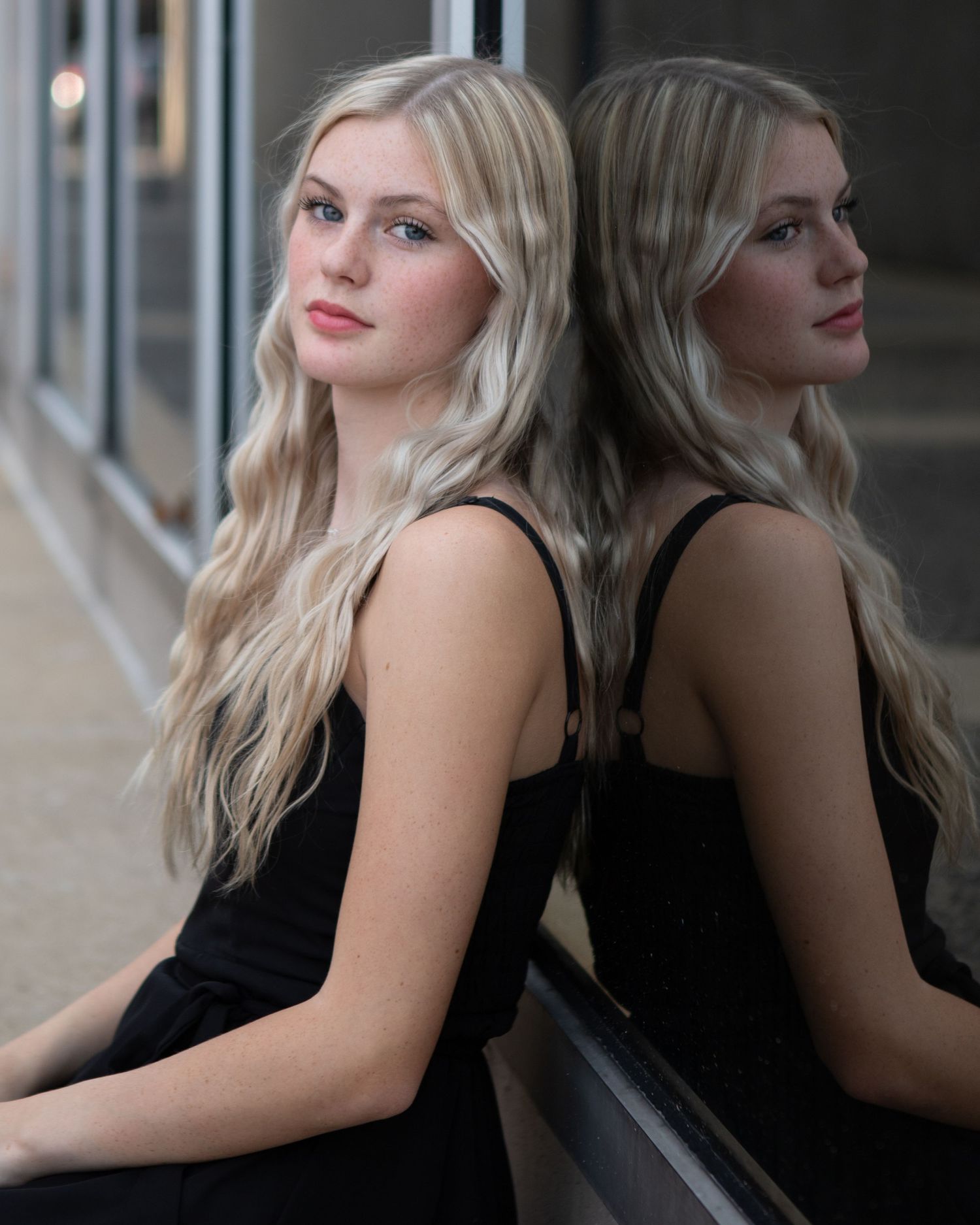 Artistic portrait series with reflective glass surface.
