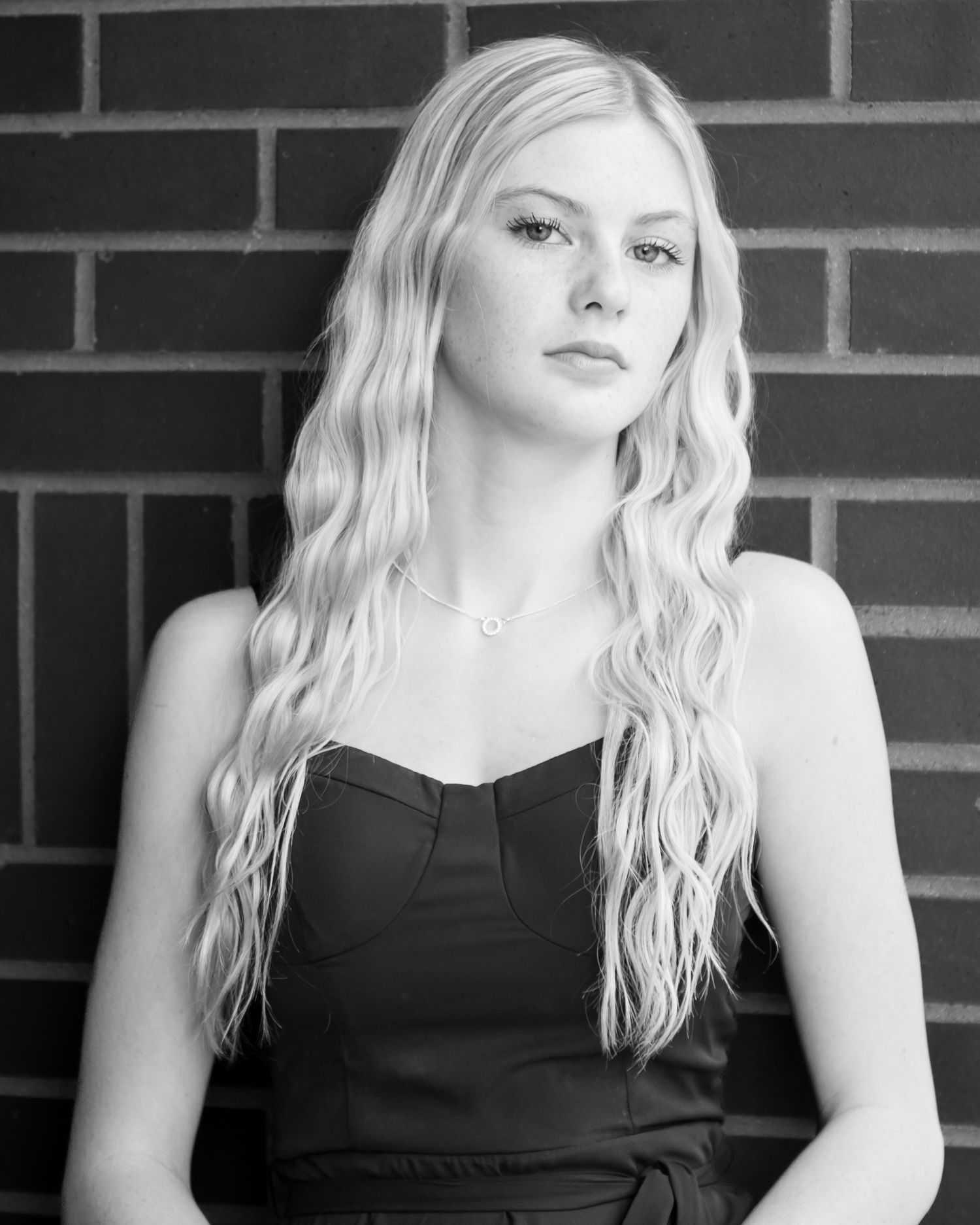 Black and white portrait series in sleeveless dress.