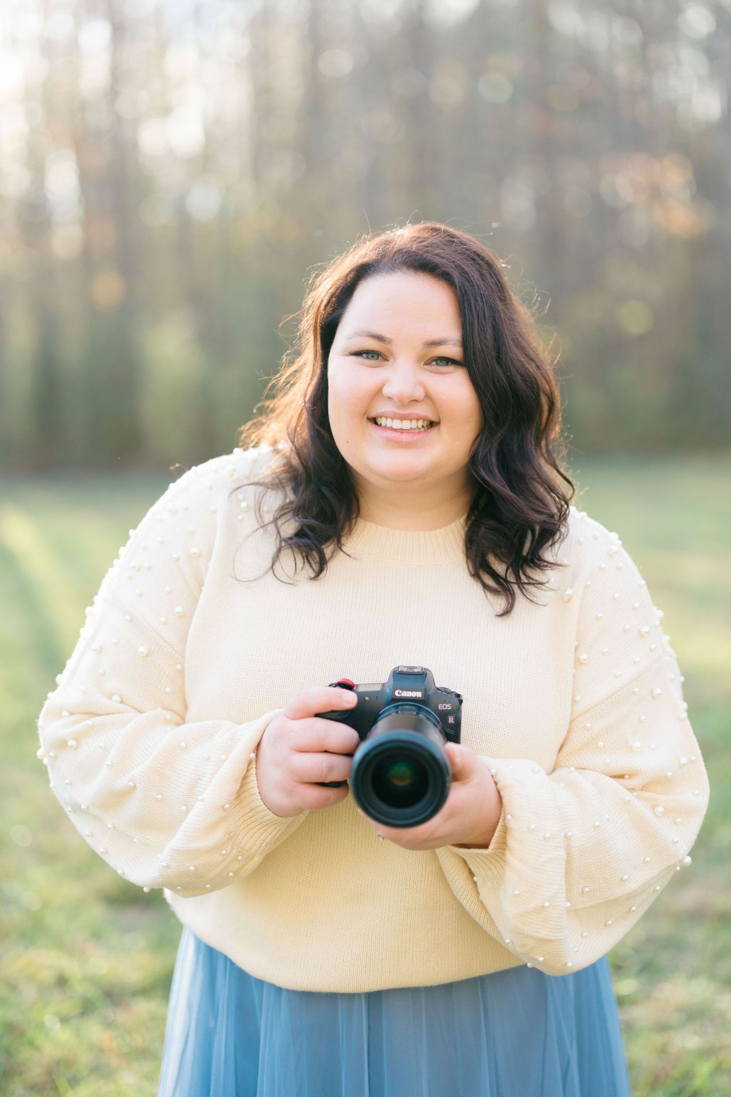 Photographer holding camera.
