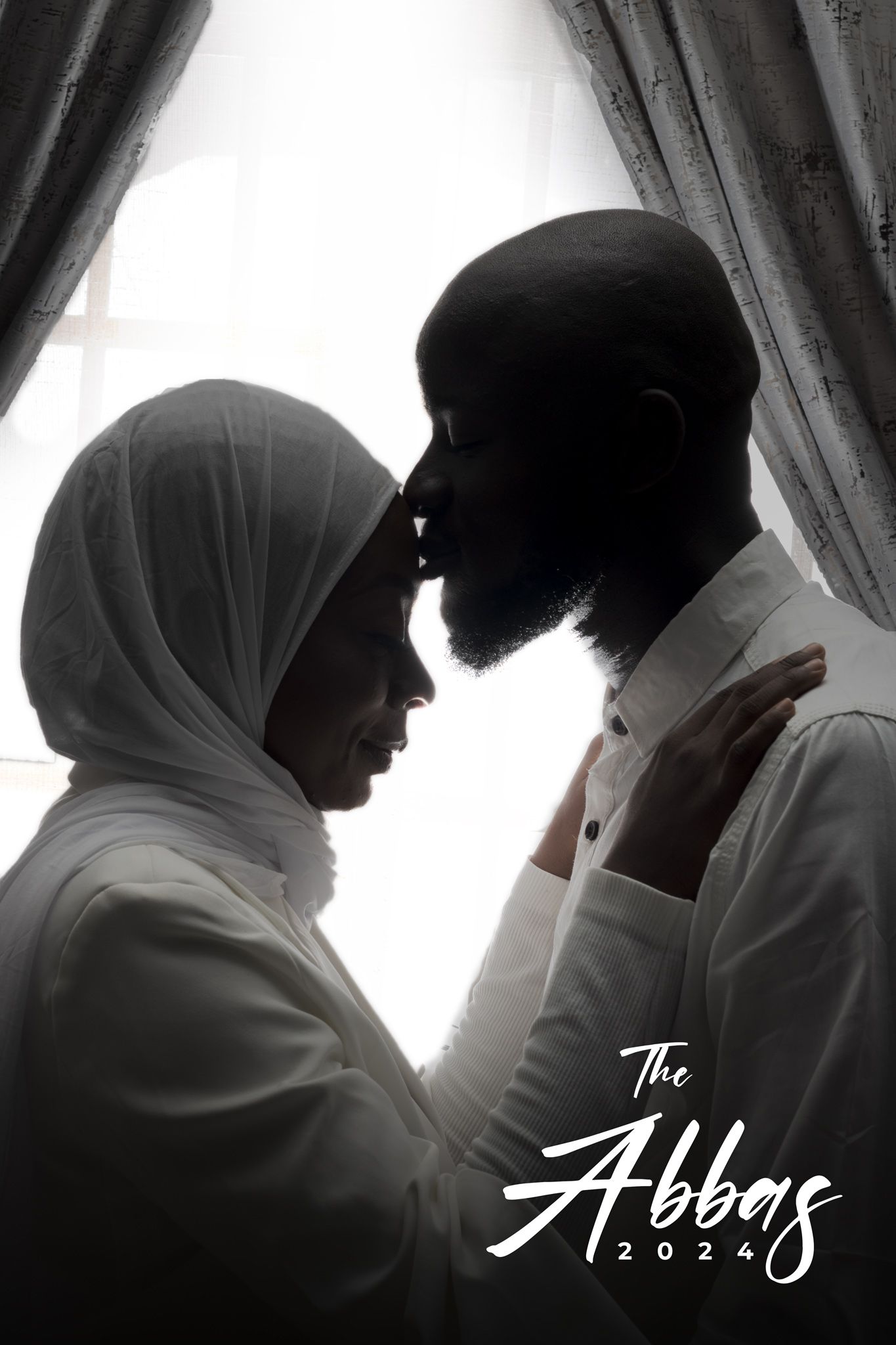 Artistic black and white portrait of Muslim couple in traditional wedding attire.