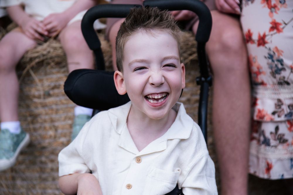 beautiful boy with a giant smile at his family photography session, in Beaudesert