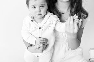 Black and white portrait of two figures in white clothing against a light background.
