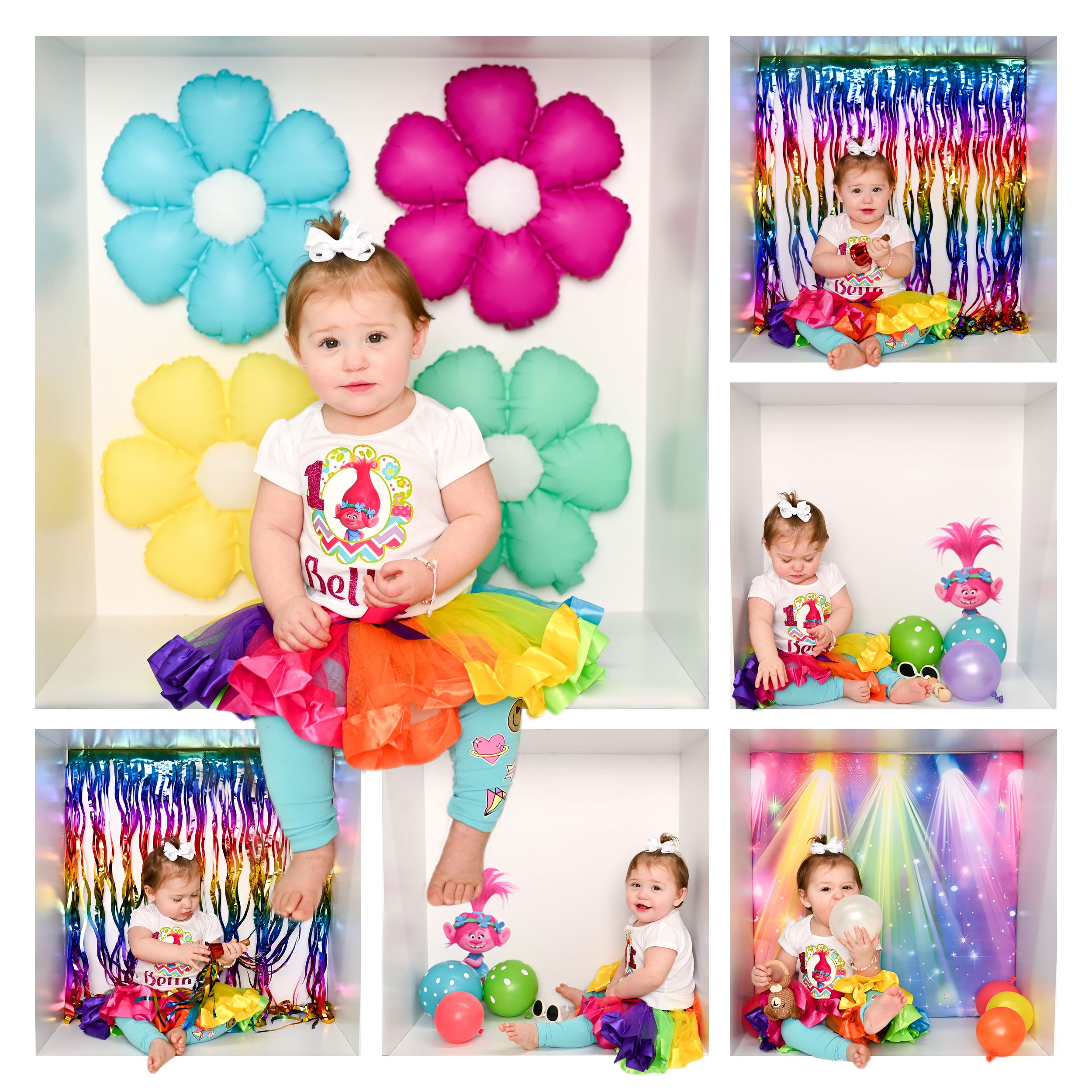 Colorful rainbow-themed photo set with large paper flowers and festive decorations.