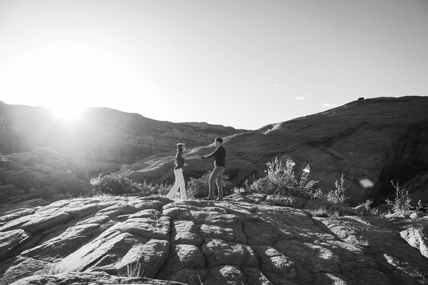 Snow Canyon Park with the shining bright. A couple is dancing far away from the view point
