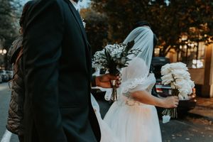 An outdoor evening wedding ceremony with decorative lighting and floral arrangements creating an intimate atmosphere.