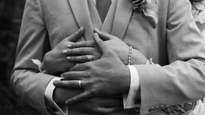 Close-up black and white photo series showing hands and rings of newlyweds in intimate poses.