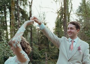 Wedding couple celebrates with confetti toss in a wooded outdoor setting during their special day.