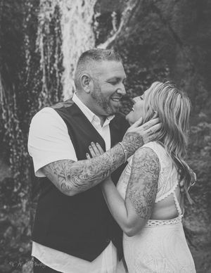 A series of romantic black and white photos showing intimate moments between a couple during a wedding photoshoot.