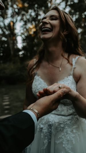 Close-up shots of a couple holding hands and sharing laughter during their wedding.