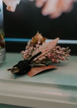 Artistic macro shot of dried flowers and decorative elements on a light surface.