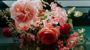 Close-up of pink and red roses arranged in an elegant floral display.