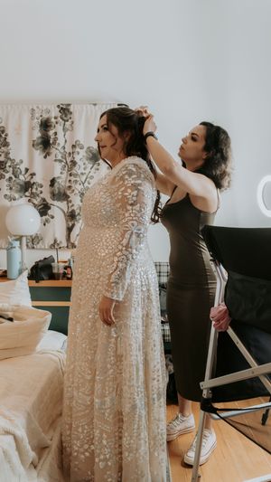 Getting ready scene with sparkly dress and preparations in a bright room.