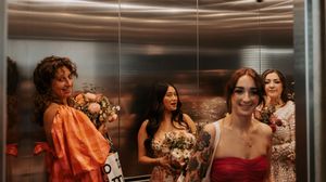 A group of people celebrate and socialize at a lively indoor party or gathering.