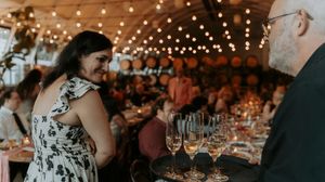Wedding reception venue decorated with romantic string lights and warm ambient lighting.