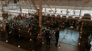 Overhead view of an event space with hanging string lights creating a magical ambiance above the guests.