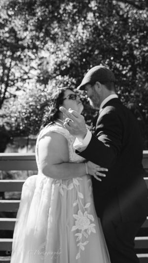 An intimate wedding moment shared between a couple in formal attire.
