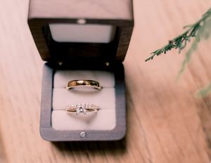 A series of five close-up photos showing a gold wedding ring and diamond engagement ring in different angles and lighting.