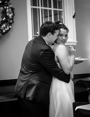 A sequence of black and white photos showing a couple embracing in formal wedding attire at an indoor venue.