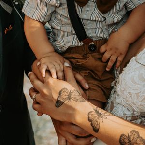 A series of photos showing a temporary butterfly tattoo being applied to someone's arm.
