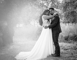 Black and white wedding photos showing romantic moments between newlyweds in a natural outdoor setting.