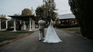 Panoramic view of an outdoor wedding venue with string lights and natural landscaping.