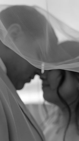 Abstract close-up of flowing white wedding dress fabric creating soft ethereal shapes.