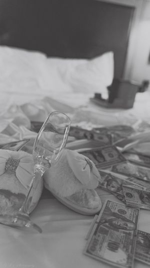 A series of baby shoes and US dollar bills arranged in a fading sequence from clear to blurry.