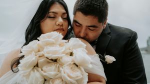 A romantic wedding photo collage showing intimate moments between newlyweds with white roses and formal attire.
