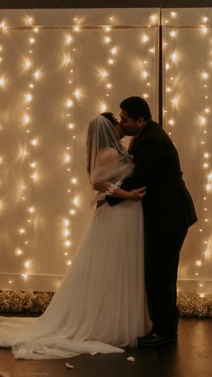 A romantic silhouetted sequence of a couple dancing in front of a twinkling light backdrop.