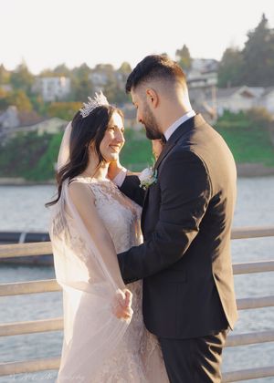 A couple shares an intimate moment during their waterfront wedding photoshoot.