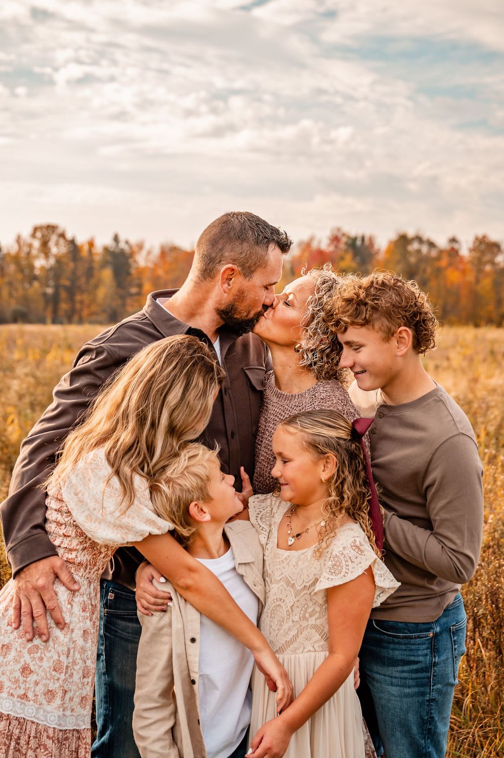 A romantic couple photoshoot series showing tender moments in a golden autumn field at sunset.