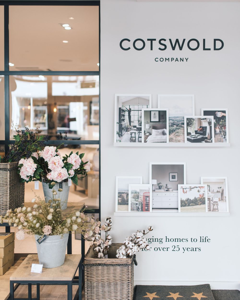 Interior design mood board showcasing neutral tones, floral arrangements, and furniture samples for a Cotswold Company project.