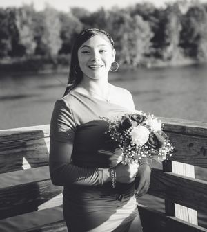 A series of black and white photos showing someone wearing a dark top while holding a corsage or floral arrangement.