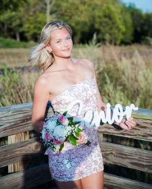 A series of outdoor portrait photographs showing someone in a white lace dress posing on a wooden boardwalk surrounded by nature.