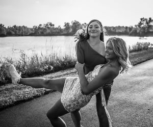 A series of black and white photos showing someone doing stretching exercises on a paved path outdoors.