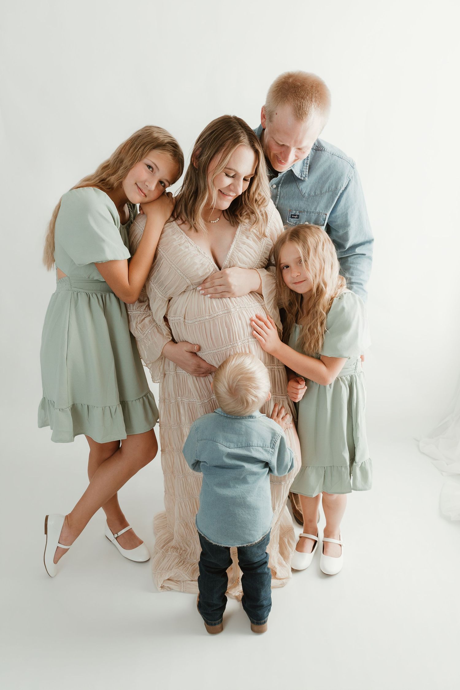Family celebrating pregnancy together during a maternity and family photography session in Tyler Texas