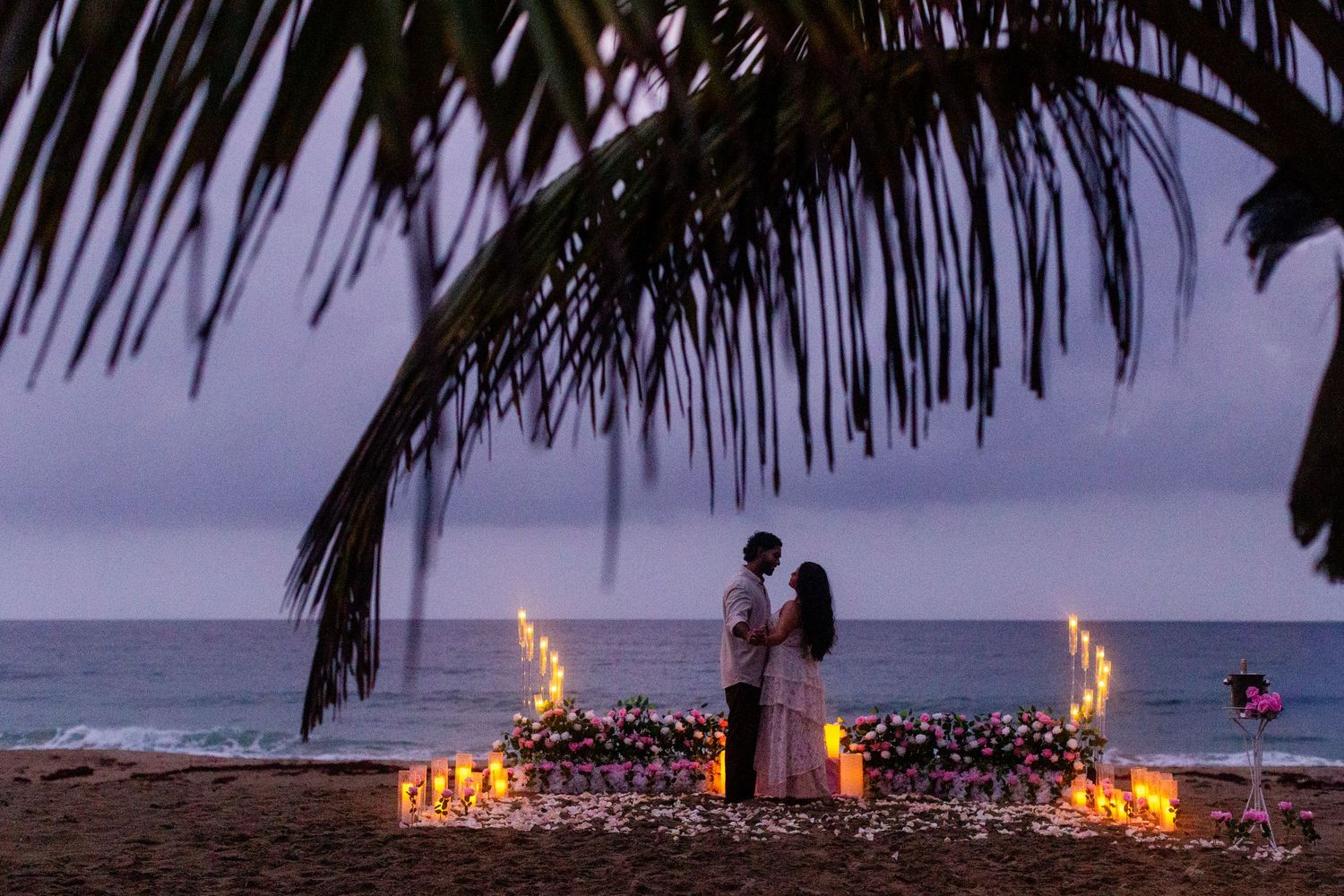 Marriage proposal on the beach with flowers and candles. Playa Guajataca, Isabela, Puerto Rico.