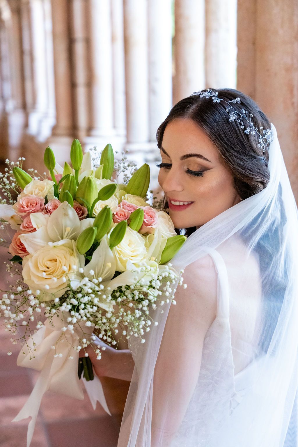 Bride holding her bouquet at The Ancient Spanish Monastery, photographed by Miami wedding photographer OkataStudio.