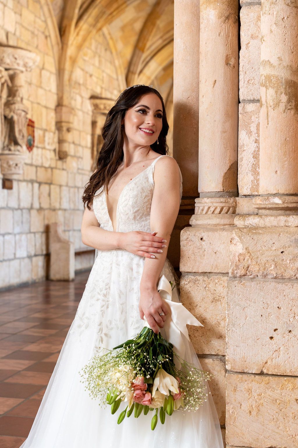 Bride holding her bouquet inside The Ancient Spanish Monastery, photographed by Miami wedding photographer OkataStudio.