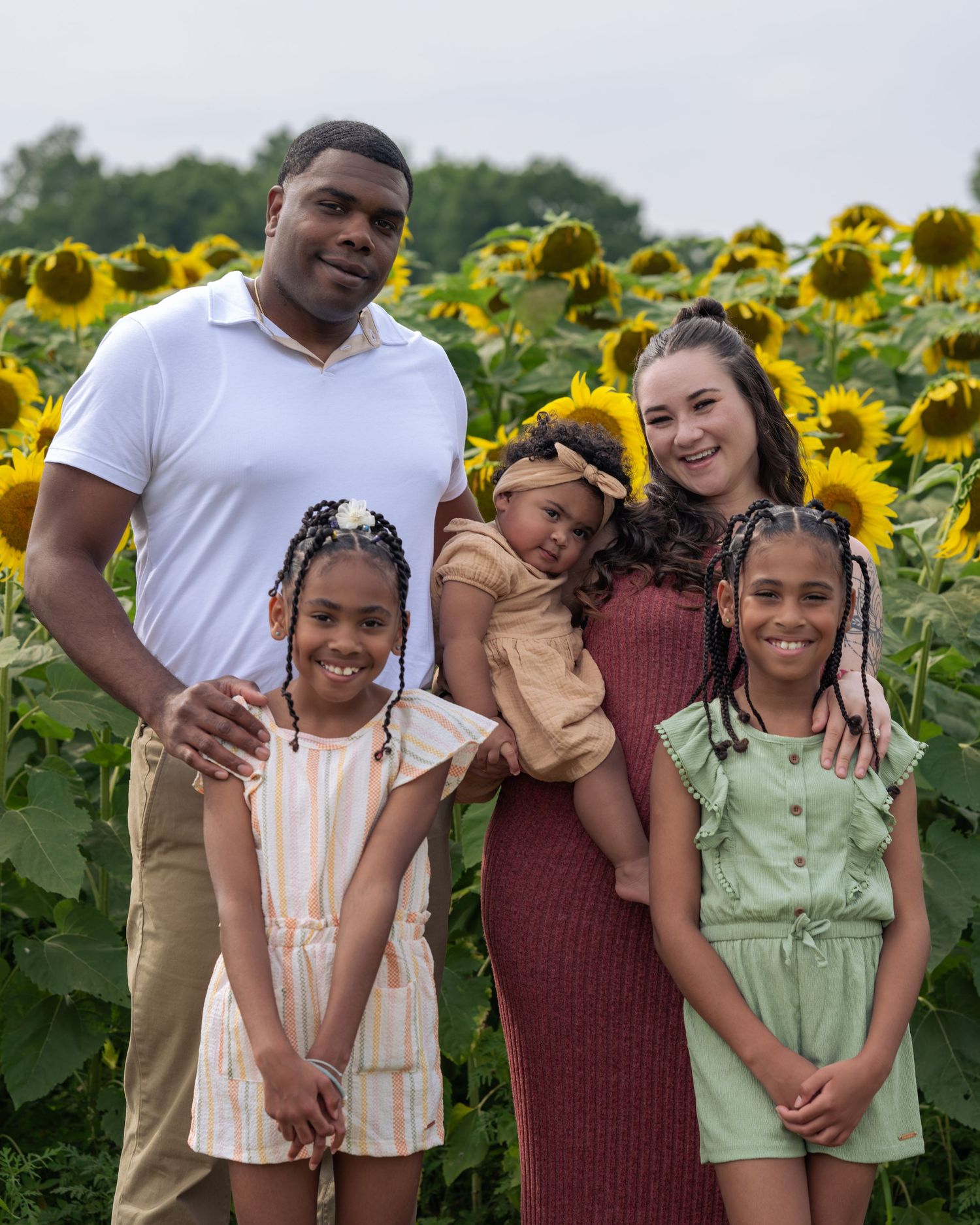 Family photo of three kids and their parents at sunflower mini sessions in New Hampshire