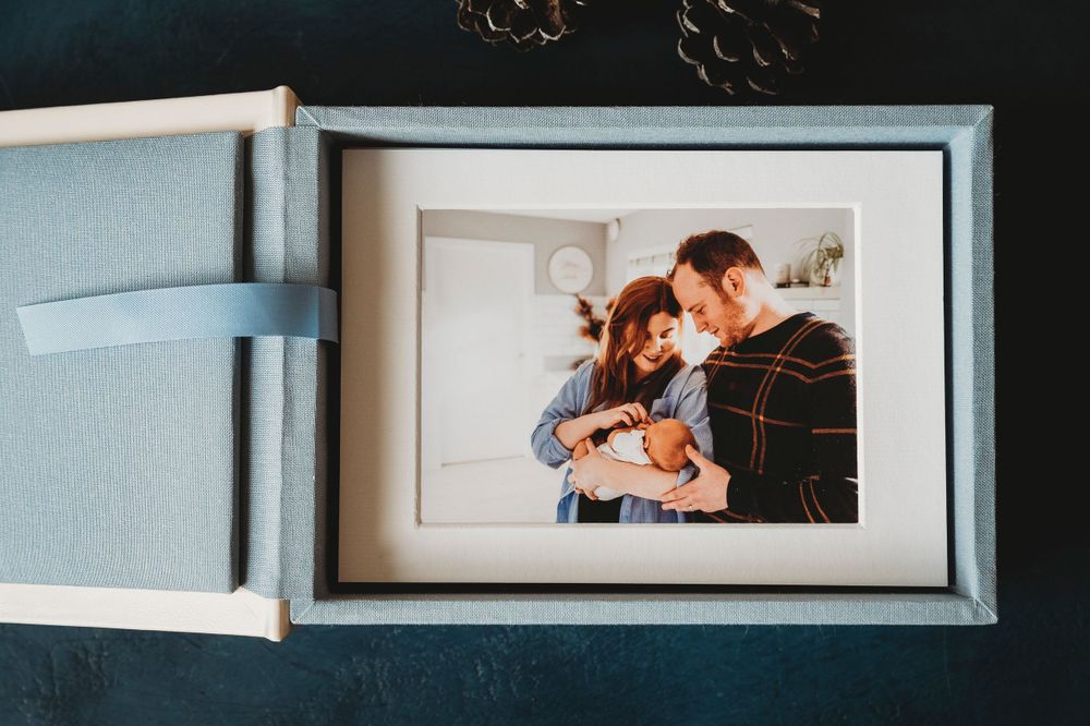 An elegant photo album box displaying a framed photograph.