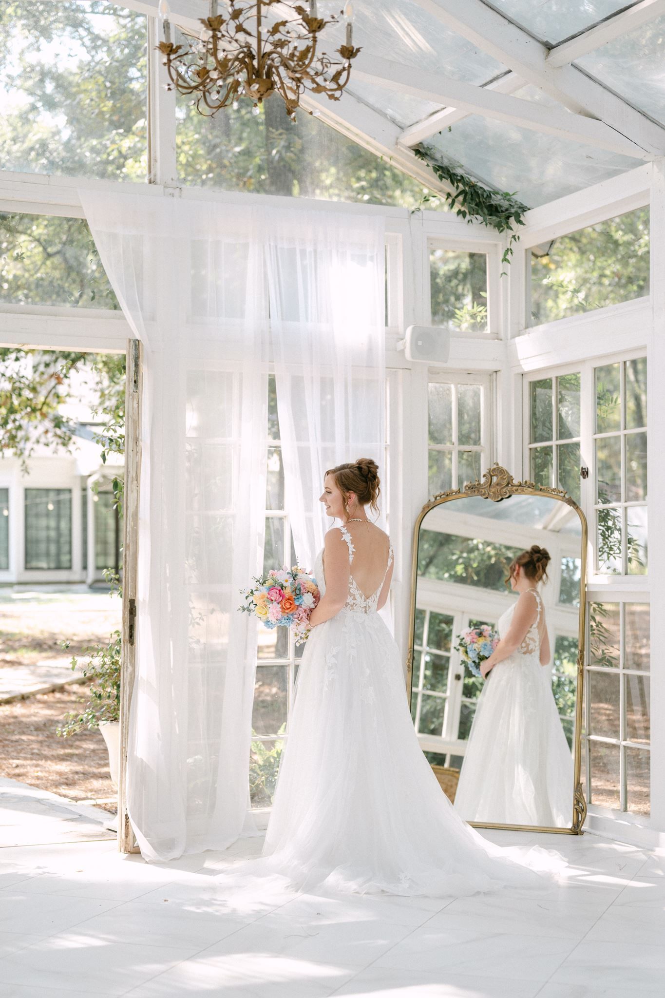 Bridal portraits in a glass house at Oak Atelier in Conroe tx.