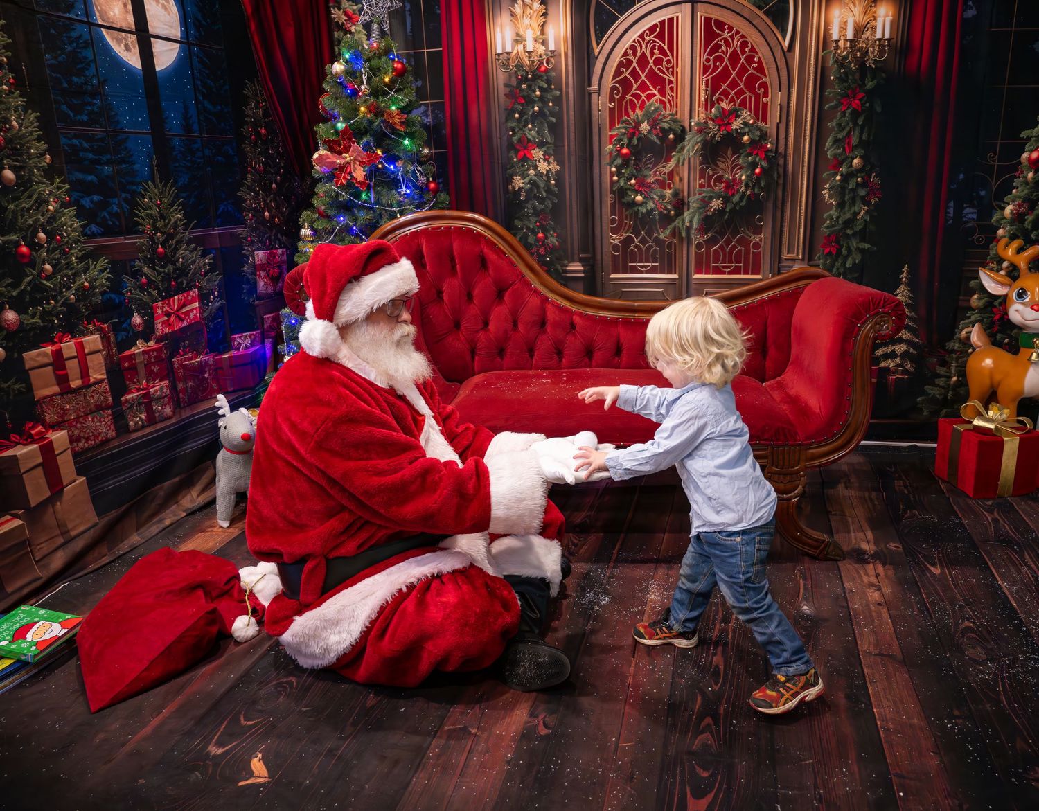 A young child meets Santa Claus in a festive Christmas setting with decorated trees and wrapped gifts.