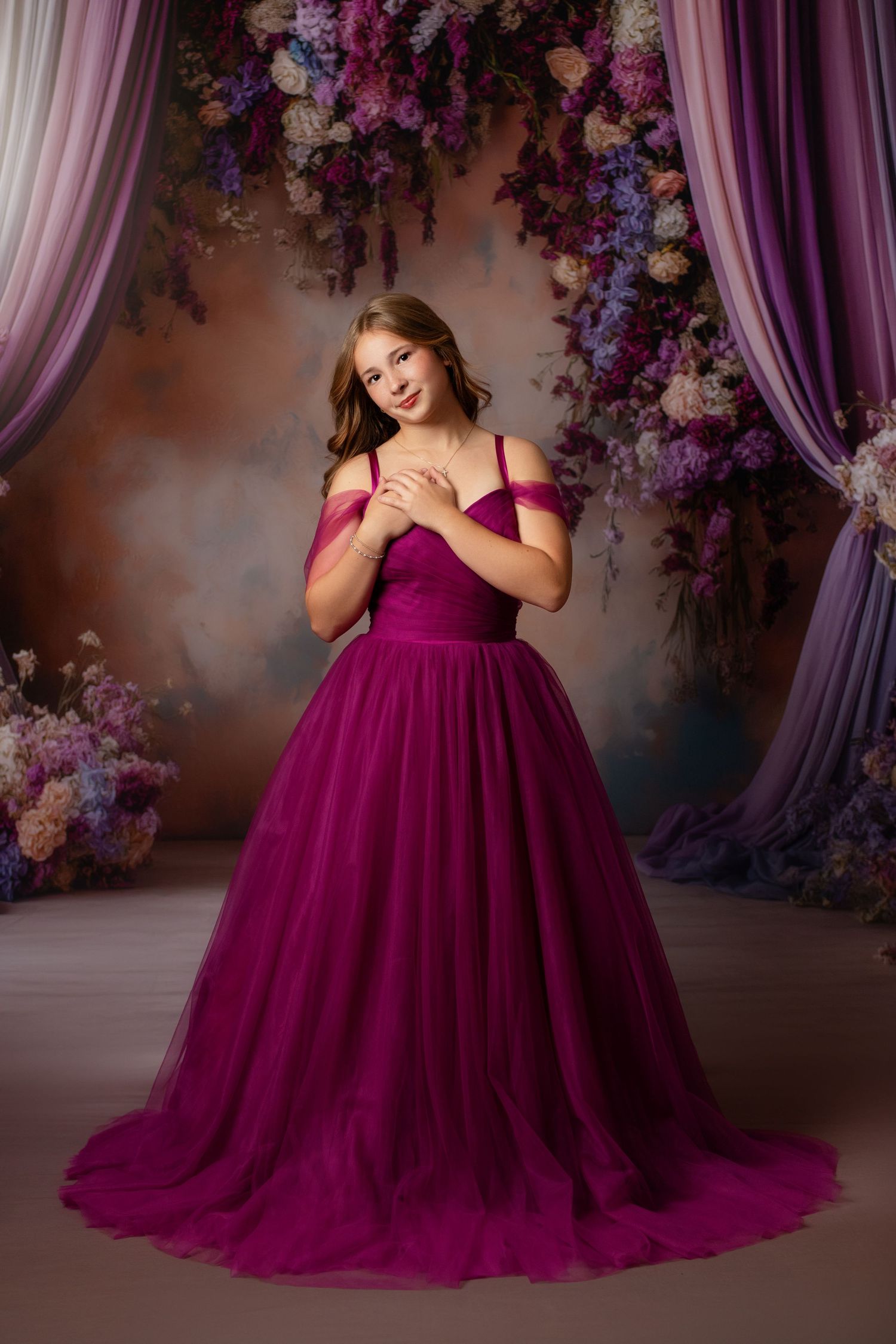 Elegant olive green ballgown with layered tulle skirt in dreamy studio portrait setting.