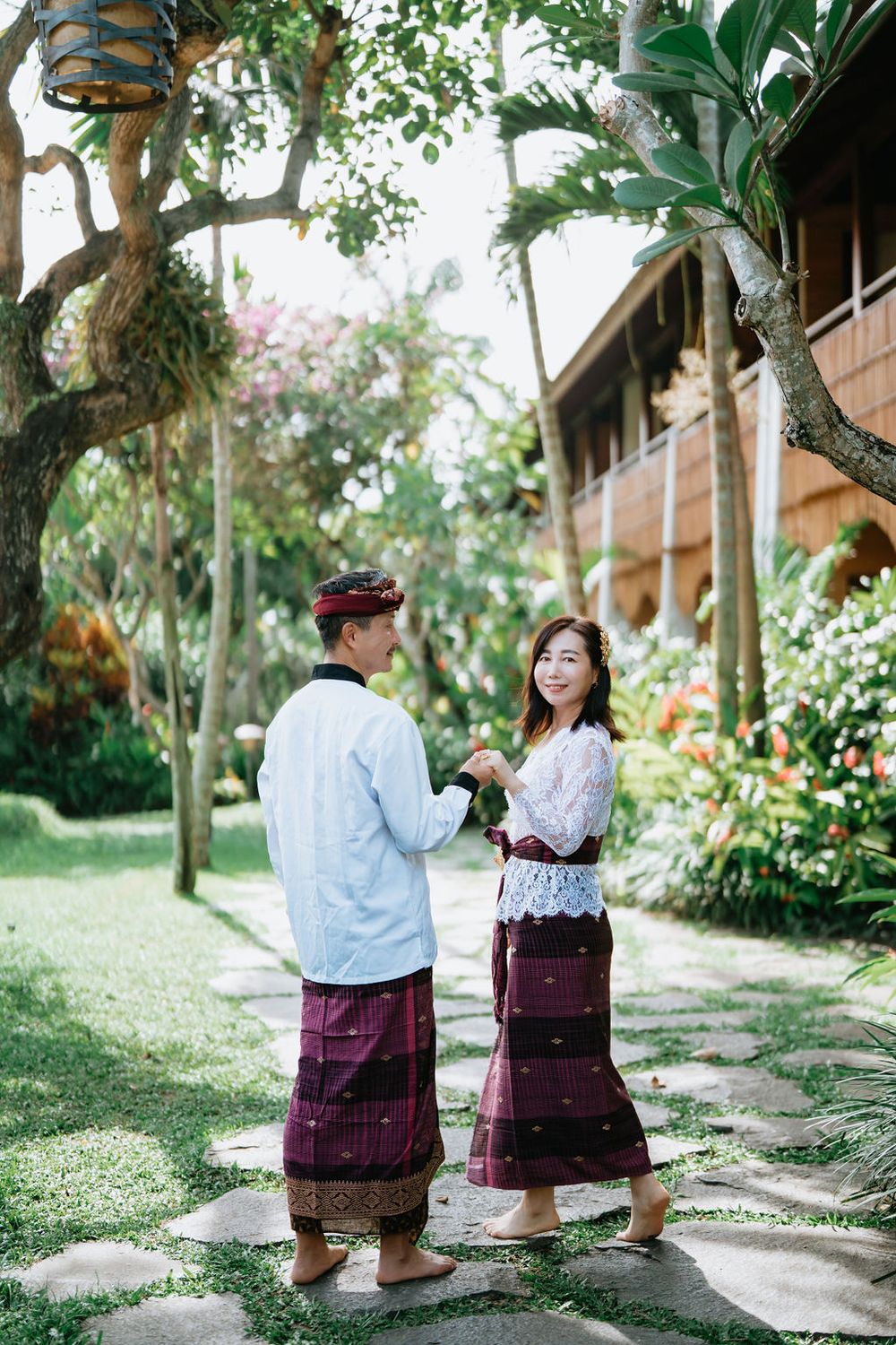 Couple wearing traditional Balinese costumes during a photoshoot at Alaya Ubud.