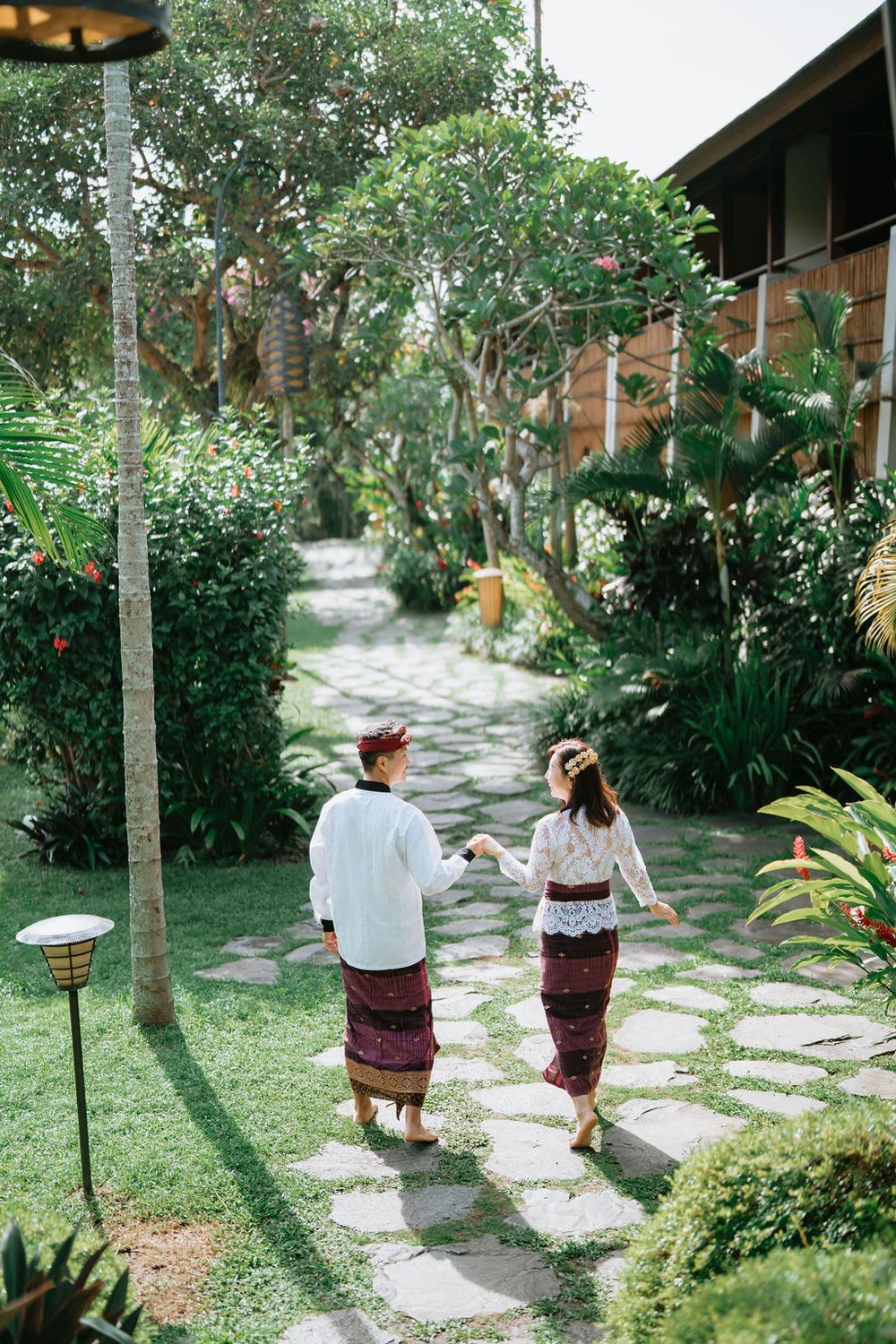 Couple wearing traditional Balinese costumes during a photoshoot at Alaya Ubud.