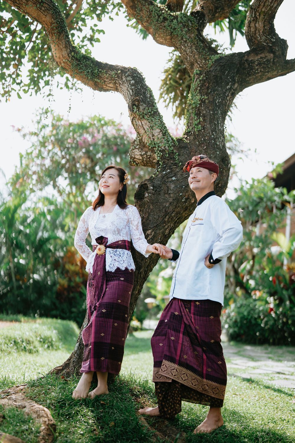 Couple wearing traditional Balinese costumes during a photoshoot at Alaya Ubud.